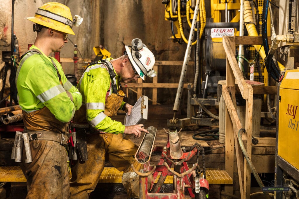 Two Workers Operating Drilling Equipment