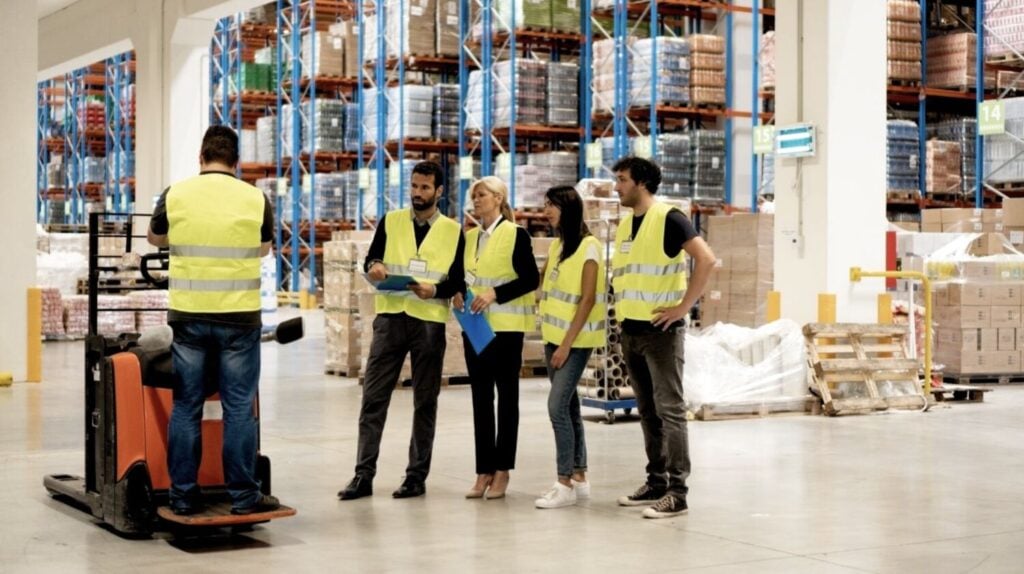 Warehouse team reviewing safety procedures on the floor