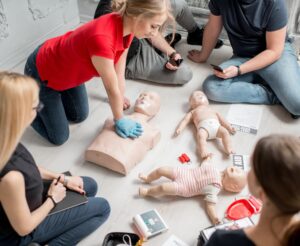 CPR-training-class-with-adult-and-infant-manikins