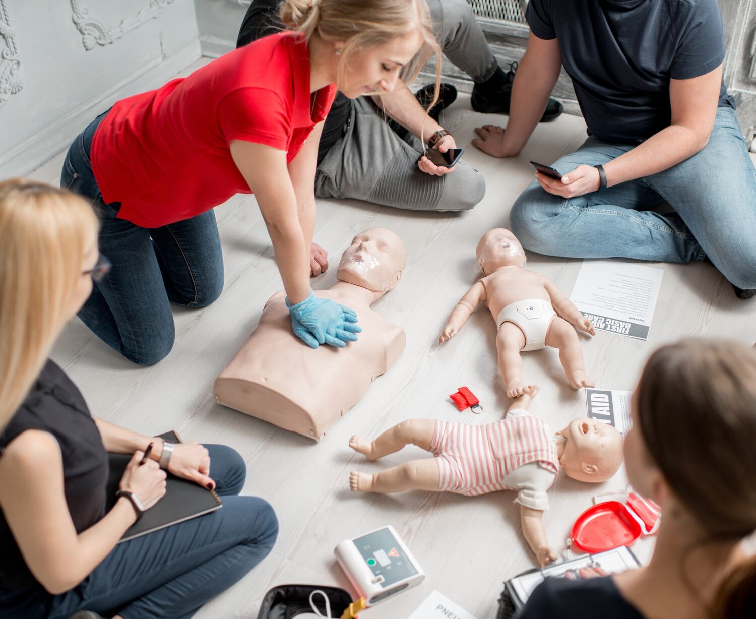 CPR-training-class-with-adult-and-infant-manikins