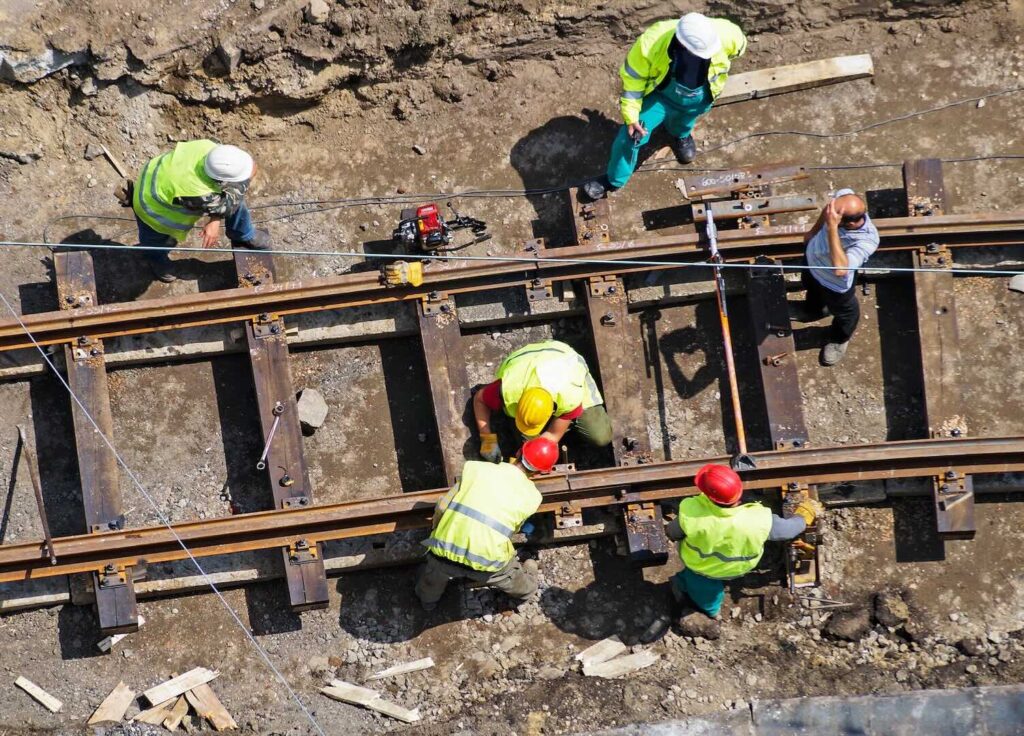 construction workers are building a new railway line