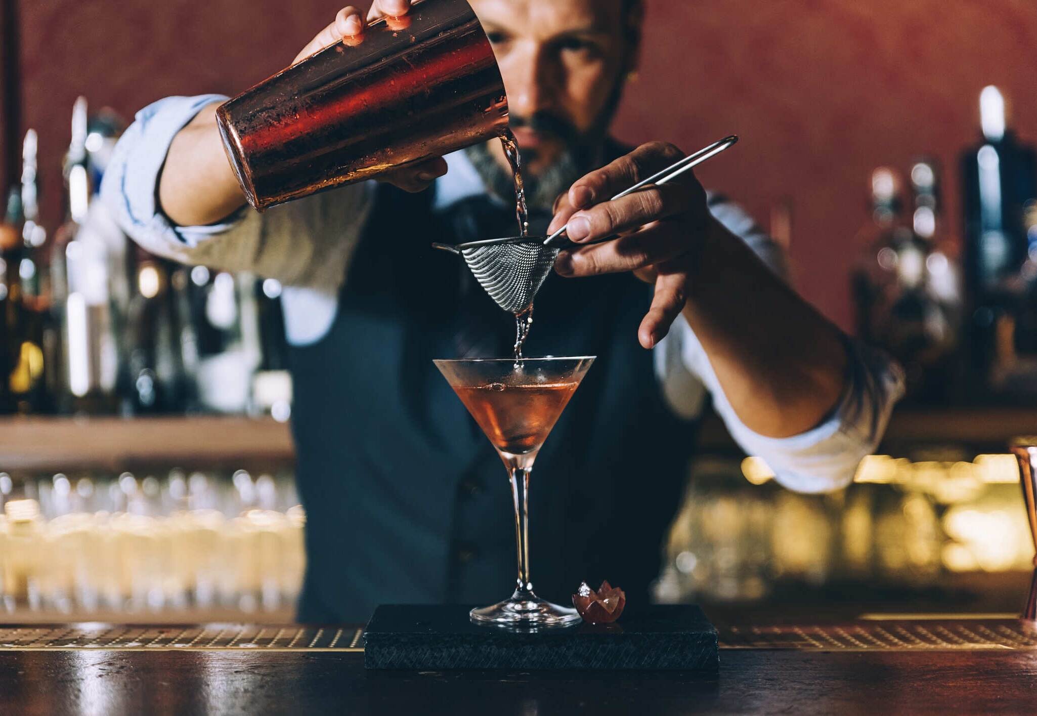 Bartender at work preparing a cocktail